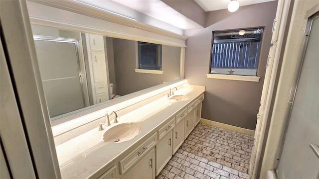 bathroom with walk in shower and vanity