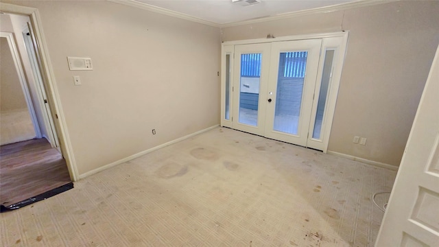 carpeted empty room with french doors and crown molding