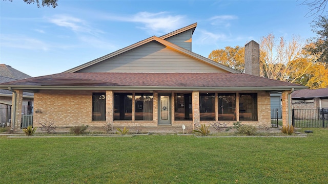 rear view of house with a yard