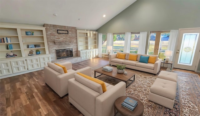 living room featuring a brick fireplace, plenty of natural light, high vaulted ceiling, and hardwood / wood-style floors