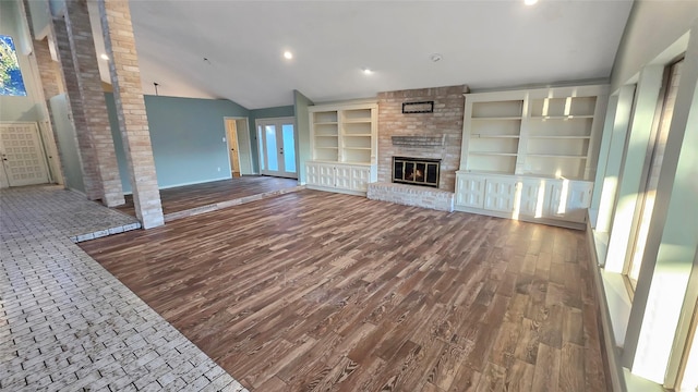 unfurnished living room featuring vaulted ceiling and a fireplace