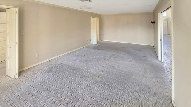 carpeted empty room with crown molding