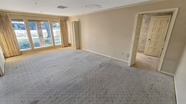 carpeted empty room with crown molding