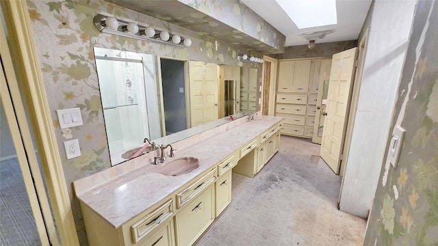 bathroom featuring vanity and a skylight