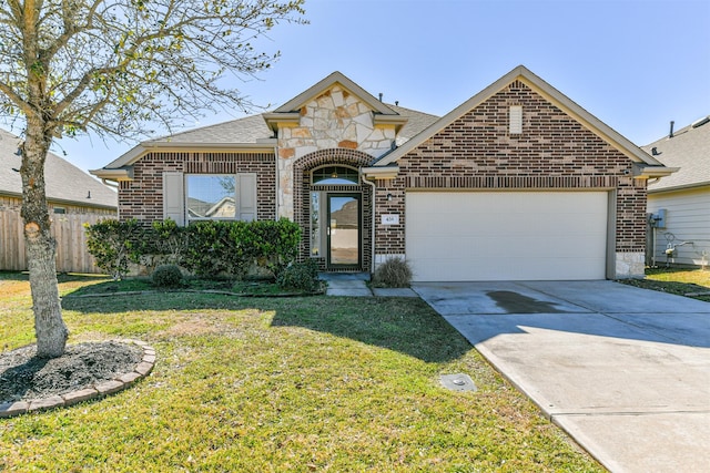 view of front of home with a garage and a front lawn