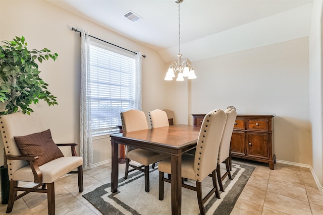 dining area with a healthy amount of sunlight, vaulted ceiling, and light tile patterned floors