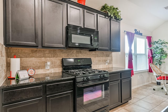 kitchen with dark stone countertops, tasteful backsplash, black appliances, light tile patterned flooring, and vaulted ceiling