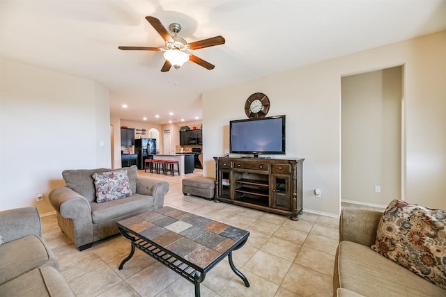 tiled living room with ceiling fan