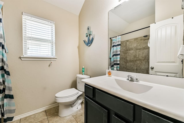 bathroom with vanity, lofted ceiling, tile patterned floors, and toilet