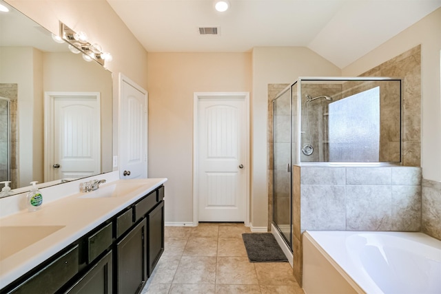 bathroom featuring vaulted ceiling, vanity, separate shower and tub, and tile patterned floors