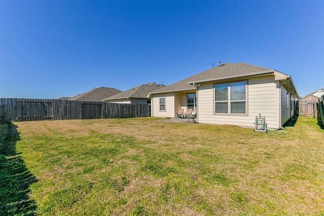 rear view of property featuring a patio and a yard