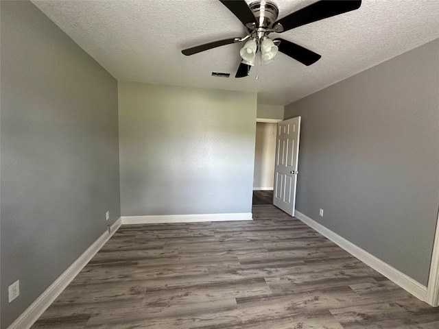 unfurnished room featuring ceiling fan, wood-type flooring, and a textured ceiling