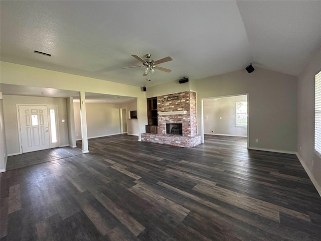 unfurnished living room with ceiling fan, a fireplace, a textured ceiling, dark hardwood / wood-style flooring, and vaulted ceiling