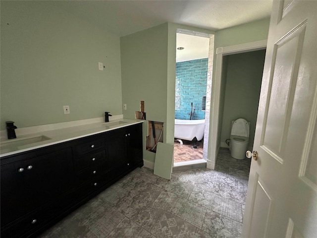 bathroom featuring vanity, a bathtub, and toilet