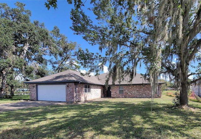 ranch-style home featuring a garage and a front lawn