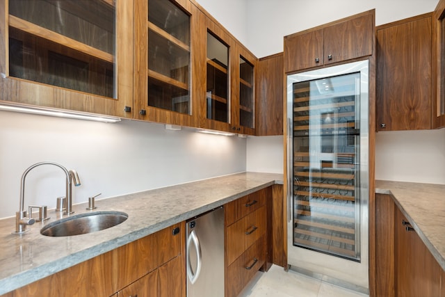 kitchen with refrigerator, sink, wine cooler, light tile patterned floors, and light stone countertops