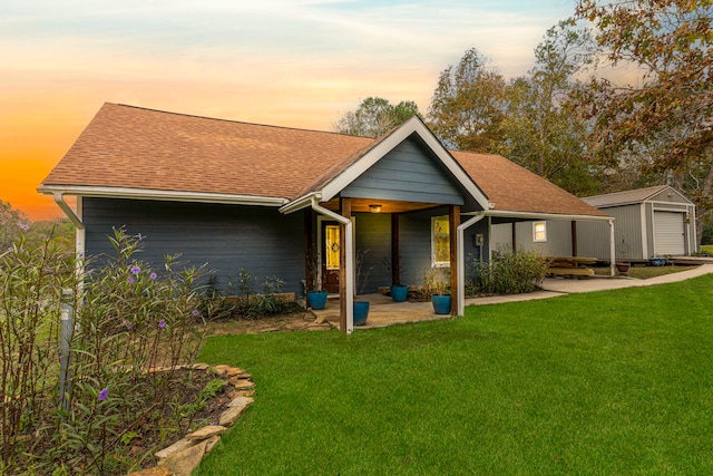 view of front of house with a shed and a lawn