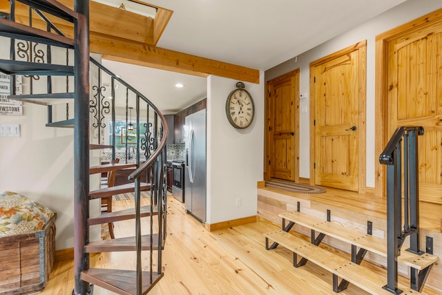 staircase with hardwood / wood-style flooring