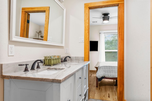 bathroom featuring vanity, hardwood / wood-style floors, and ceiling fan