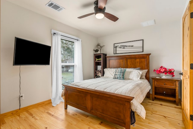 bedroom with ceiling fan and light hardwood / wood-style floors