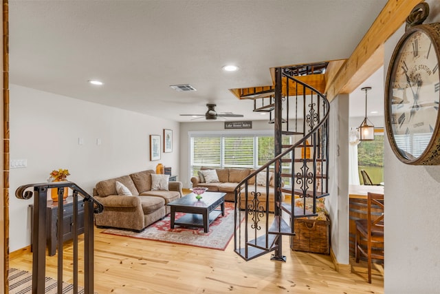 living room with hardwood / wood-style flooring and ceiling fan