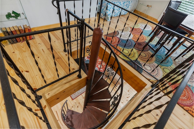 stairway with hardwood / wood-style flooring