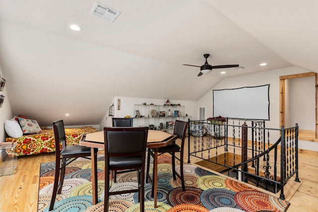 dining space with lofted ceiling, ceiling fan, and light hardwood / wood-style flooring