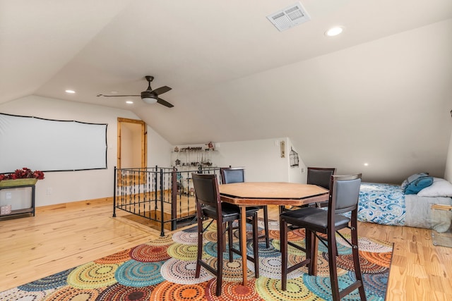 dining space with ceiling fan, lofted ceiling, and light hardwood / wood-style floors