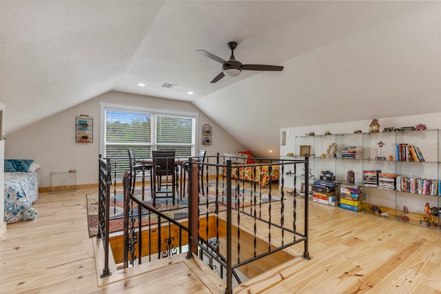 additional living space featuring vaulted ceiling, hardwood / wood-style floors, and ceiling fan