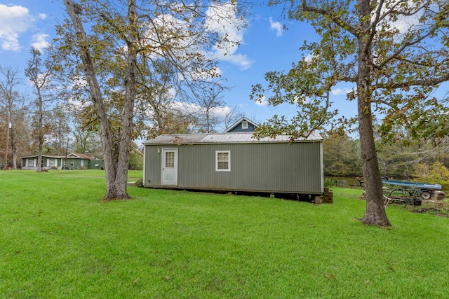 exterior space with an outbuilding and a yard