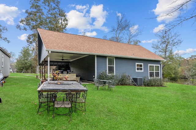 rear view of property with cooling unit, a lawn, and ceiling fan