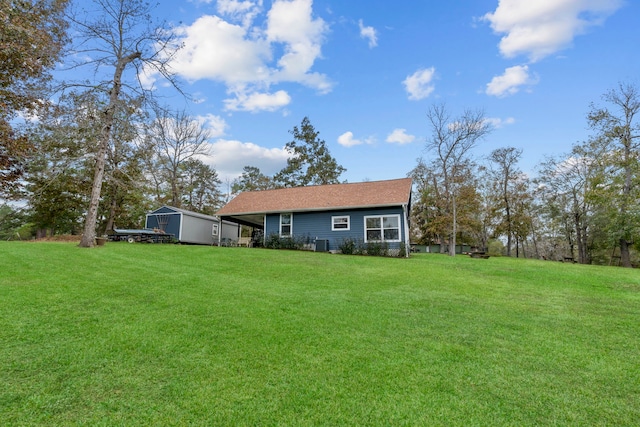 exterior space with a yard and a storage unit