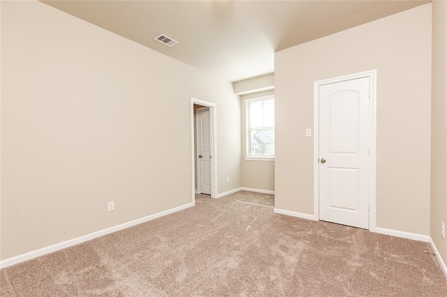 unfurnished bedroom featuring light carpet