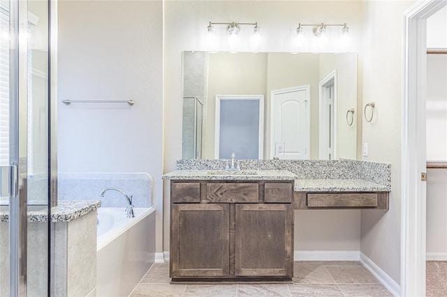 bathroom featuring tile patterned flooring, shower with separate bathtub, and vanity