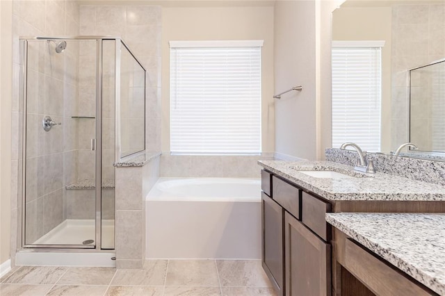 bathroom with vanity, plenty of natural light, and plus walk in shower