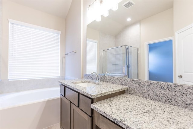 bathroom with plus walk in shower and vanity