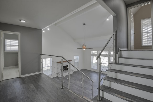 stairway with hardwood / wood-style flooring, ceiling fan, and lofted ceiling with beams