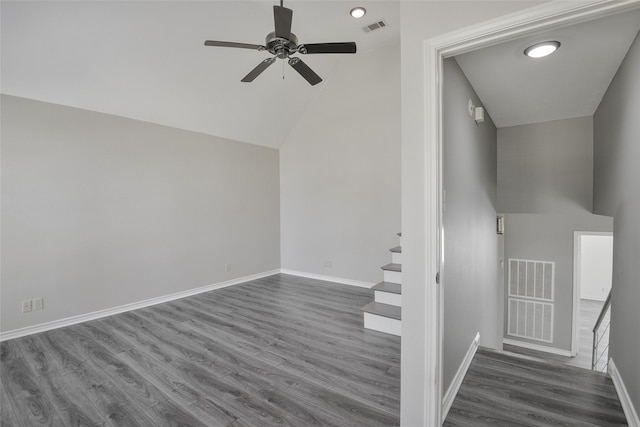 stairs featuring ceiling fan, wood-type flooring, and high vaulted ceiling