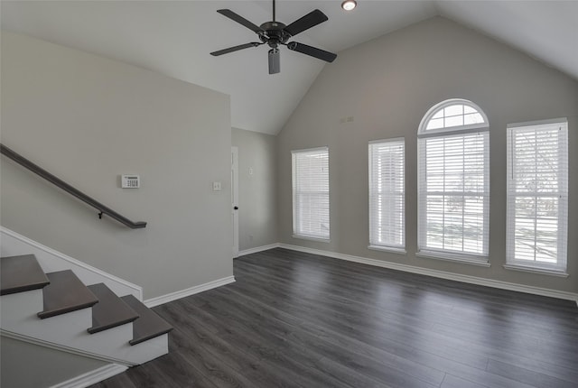 unfurnished living room with ceiling fan, dark hardwood / wood-style floors, and vaulted ceiling