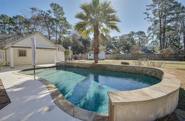 view of swimming pool featuring a storage shed and a patio