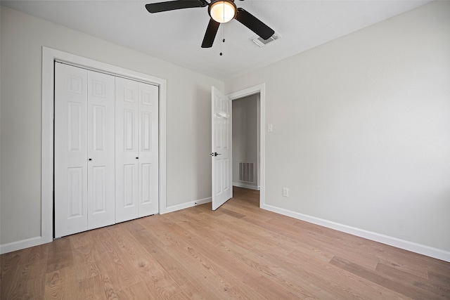 unfurnished bedroom featuring light hardwood / wood-style flooring, a closet, and ceiling fan