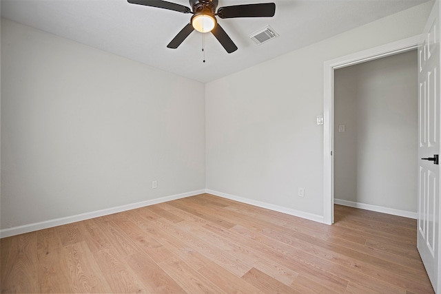 spare room with ceiling fan and light wood-type flooring