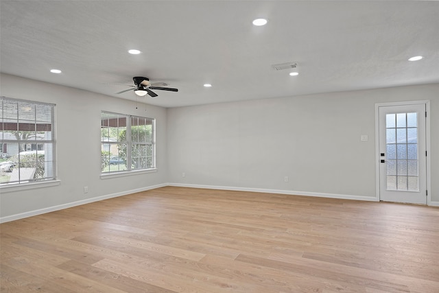 spare room featuring ceiling fan and light hardwood / wood-style floors