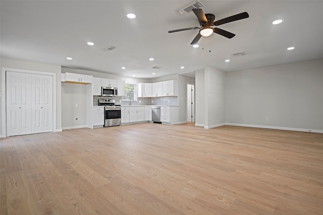 unfurnished living room with ceiling fan and light hardwood / wood-style floors