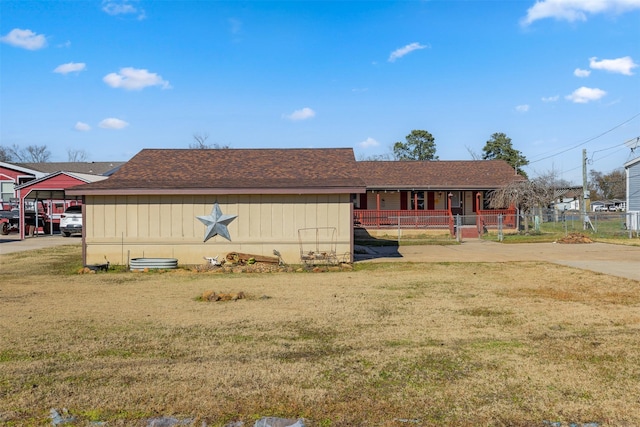 exterior space with a carport and a front yard