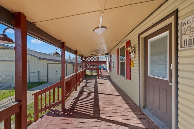 wooden deck featuring a porch and ceiling fan