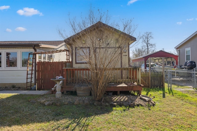 back of property with a yard and a deck