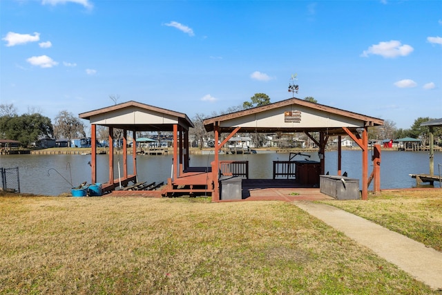 view of dock featuring a lawn and a water view