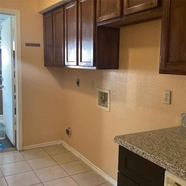 laundry room with hookup for a washing machine, light tile patterned flooring, hookup for an electric dryer, and cabinets