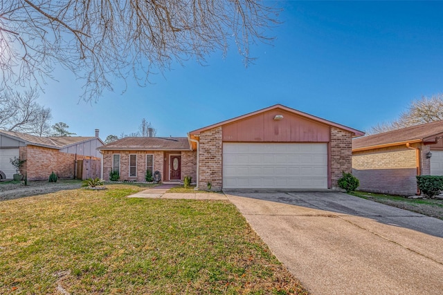 mid-century home with a garage, driveway, brick siding, and a front yard